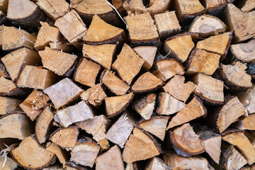 A stack of seasoned firewood logs seen from the front.