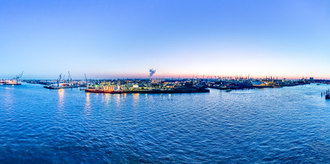 Obraz premium Aerial view of Hamburg Harbor, Germany, at dusk. The Port of Hamburg (Hamburger Hafen) is a sea port on the river Elbe. It is Germany's largest port and the second-busiest port in Europe.