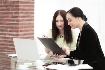 close up. business woman making notes sitting on her Desk