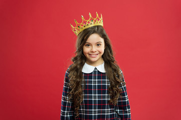 Kid wear golden crown symbol princess. Every girl dreaming become princess. Lady little princess. Girl wear crown red background. Spoiled child concept. Egocentric princess. World spinning around me