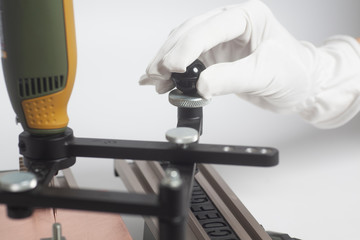 Worker hands on Engraving device pantograph with CNC engraver with letterpress alphabet