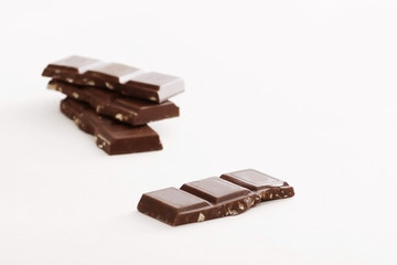 stack pieces of chocolate with nuts isolated on white