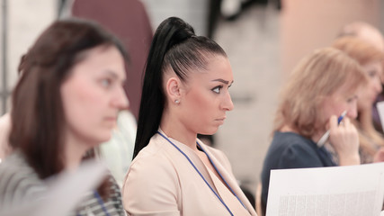 group of business people with documents sitting at the lecture hall.