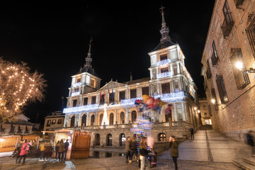 Night scene of Toledo town hall in christmas time, unrecognizable people is in the scene, Toledo, Spain.