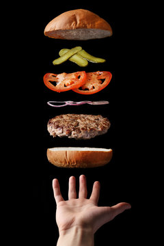 fly burger with hand. floating food levitating burger