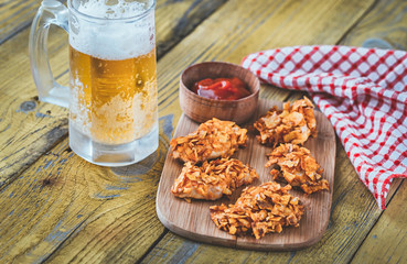 Barbecue chicken bites with mug of beer