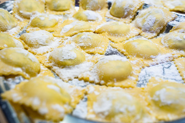 Making italian pasta Ravioli for Christmas, child with grandparents