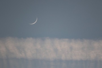 Obraz na płótnie Canvas Sliver of the moon over clouds in San Diego