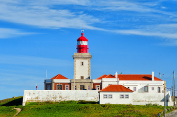 Fototapeta na wymiar Lighthouse at Cape Roca. Cabo da Roca most western point in Europe. Landmark in Sintra and Lisbon, Portugal