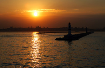 Naklejka premium During the sunset breakwater, historical peninsula and Hagia Sofia, Istanbul, Turkey. This picture was taken from the Kadikoy District.