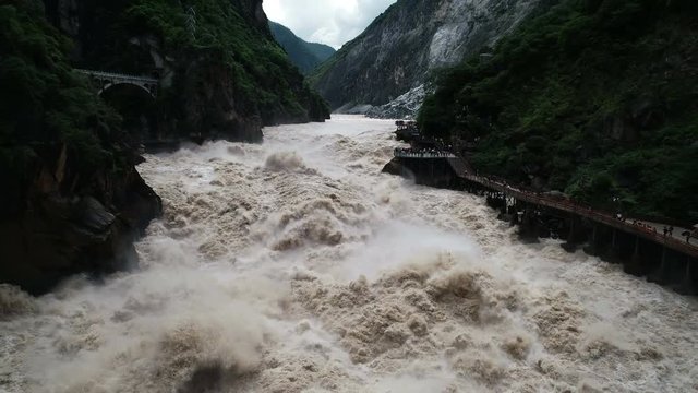 Slow motion drone shot of stunning mountain canyon at famous Tiger Leaping Gorge in China