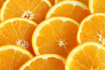 Food background - slices of ripe orange fruits