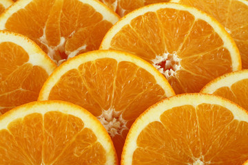 Food background - slices of ripe orange fruits