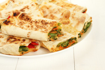Roasted rolls of bread lavash filled with red sweet paprika, herbs and cheese