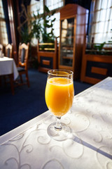 glass of orange juice at the table