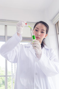 asian women scientist carrying out research in a chemistry lab.