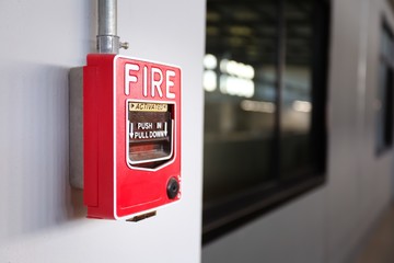 Fire alarm switch on the wall in factory. - obrazy, fototapety, plakaty