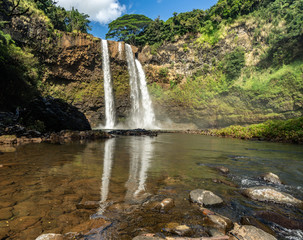 Featured in an 80's TV show, these  double-tiered iconic falls, are one of the more recognized sights of the island, Wailua Falls, Kauai, Hawaii