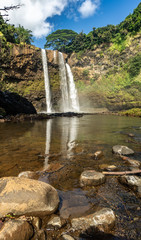 Featured in an 80's TV show, these  double-tiered iconic falls, are one of the more recognized sights of the island, Wailua Falls, Kauai, Hawaii