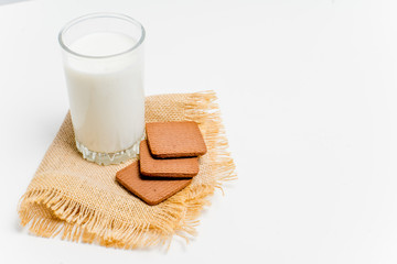 a glass of milk with bread and grains