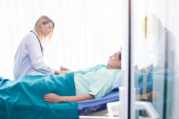 Nurse discussing take care of man patients closely in hospital