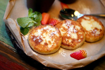 Macro photo of delicious fresh curd cheesecakes with sour cream