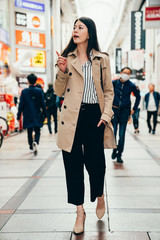 woman in smart casual suit walking joyful