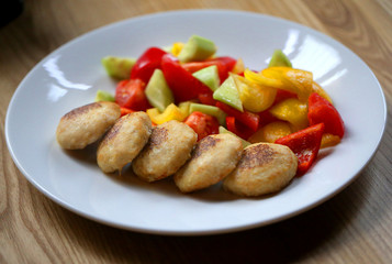 Macro photo of delicious pike burgers with vegetables on a white plate