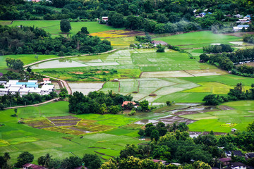 Fototapeta na wymiar High angle view of cities fields and trees. And a lot of cloud in the sky. - Loei ,Thailand Asia.