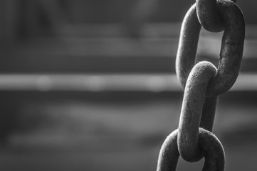 Close-up of a thick iron chain in black and white for lifting heavy equipments