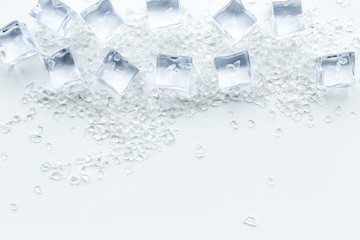 crashed ice cubes on white kitchen table top view mock up