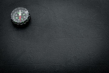 direction and movement concept with compass on black background top view mock up