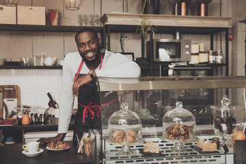 Smiling afro american barista male at work - obrazy, fototapety, plakaty