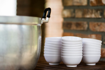 The pot with food and equipment to eat.