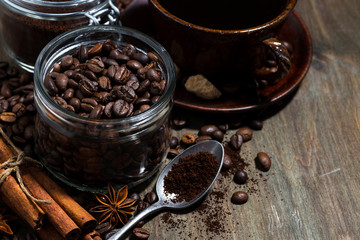 roasted coffee beans and spices on wooden background, concept photo, closeup