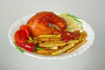 Baked chicken, french fries and vegetables