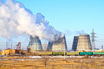 Territory of heat and power station. Accumulator tanks and cooling towers. Winter