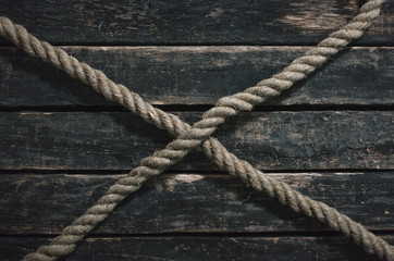 Rope on the wooden surface background.