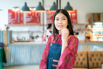 Confident business entrepreneur smiling women standing with coffee shop background