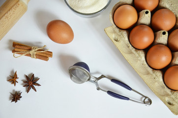 Fototapeta na wymiar Egg, cinnamon, honey, almond flour, flax seeds, vanilla extract, salt. Ingredients for bread muffins. rolling pin, star of anis on the white background