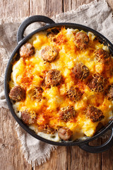 Main course from Cheese Potato and Smoked Sausage Casserole closeup on the pan. Vertical top view