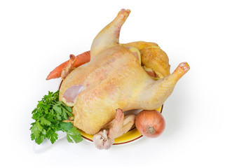 Uncooked gutted carcass of broiler reared outdoors and vegetables