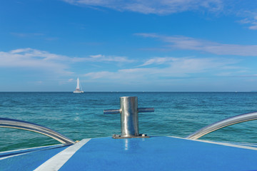Seascape with sailboat on a clear sunny day. View from the bow of the yacht