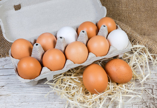 Chicken eggs in paper pulp carton and separately beside