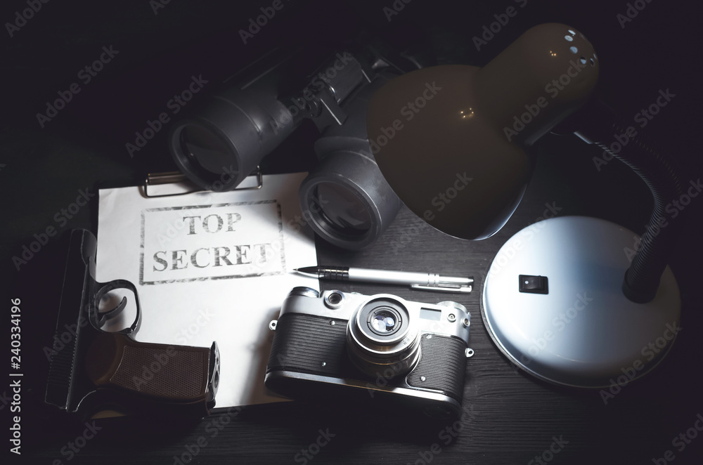 Wall mural top secret information data on the secret service agent table background. espionage concept.