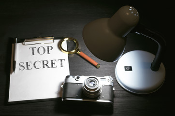 Top secret documents file on a detective agent table background. Espionage concept.