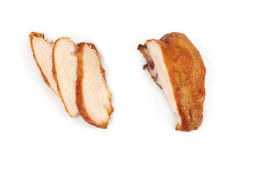 A close up of grilled, sliced chicken breast isolated on white background .