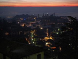 Bergamo, one of the most beautiful city in Italy. Amazing landscape of the old town and the fog covers the plain at sunrise