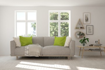 Idea of white room with sofa and summer landscape in window. Scandinavian interior design. 3D illustration