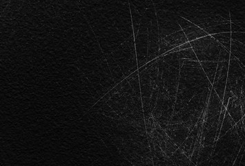 Old black stucco wall with white scratches and scuffs texture. textured grunge black board with chalk
